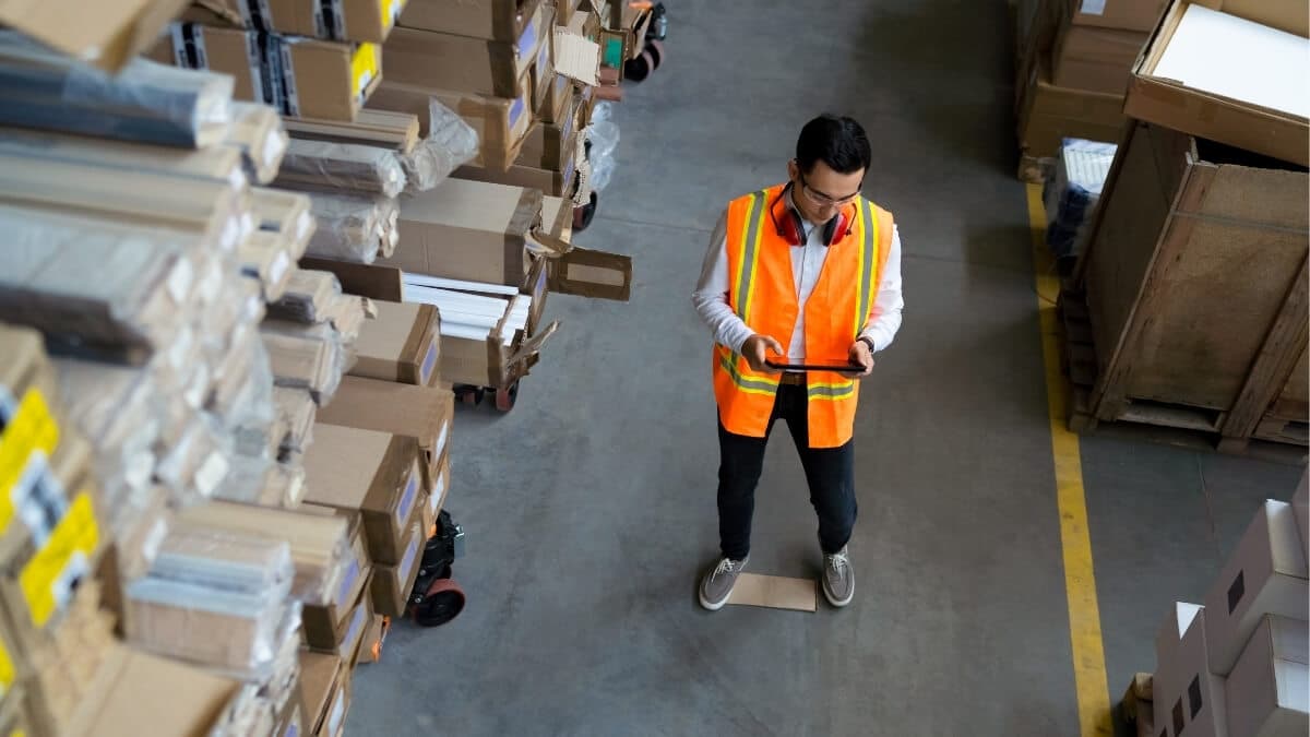 Warehouse team collaborating to streamline processes and reduce operational waste