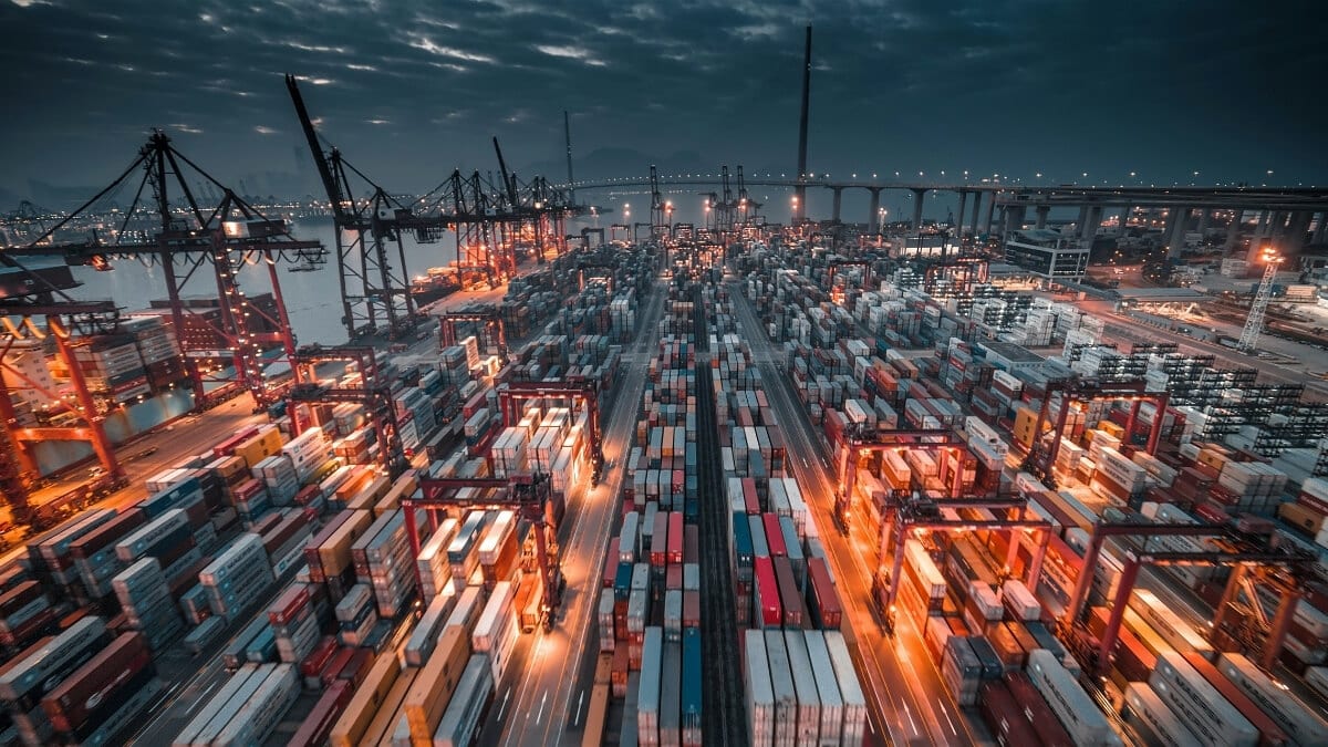 Massive container port at night representing global supply chain logistics and predictive inventory management.